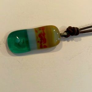 Glass amber green charm corded necklace 2in long x 1.5 wide brown cord